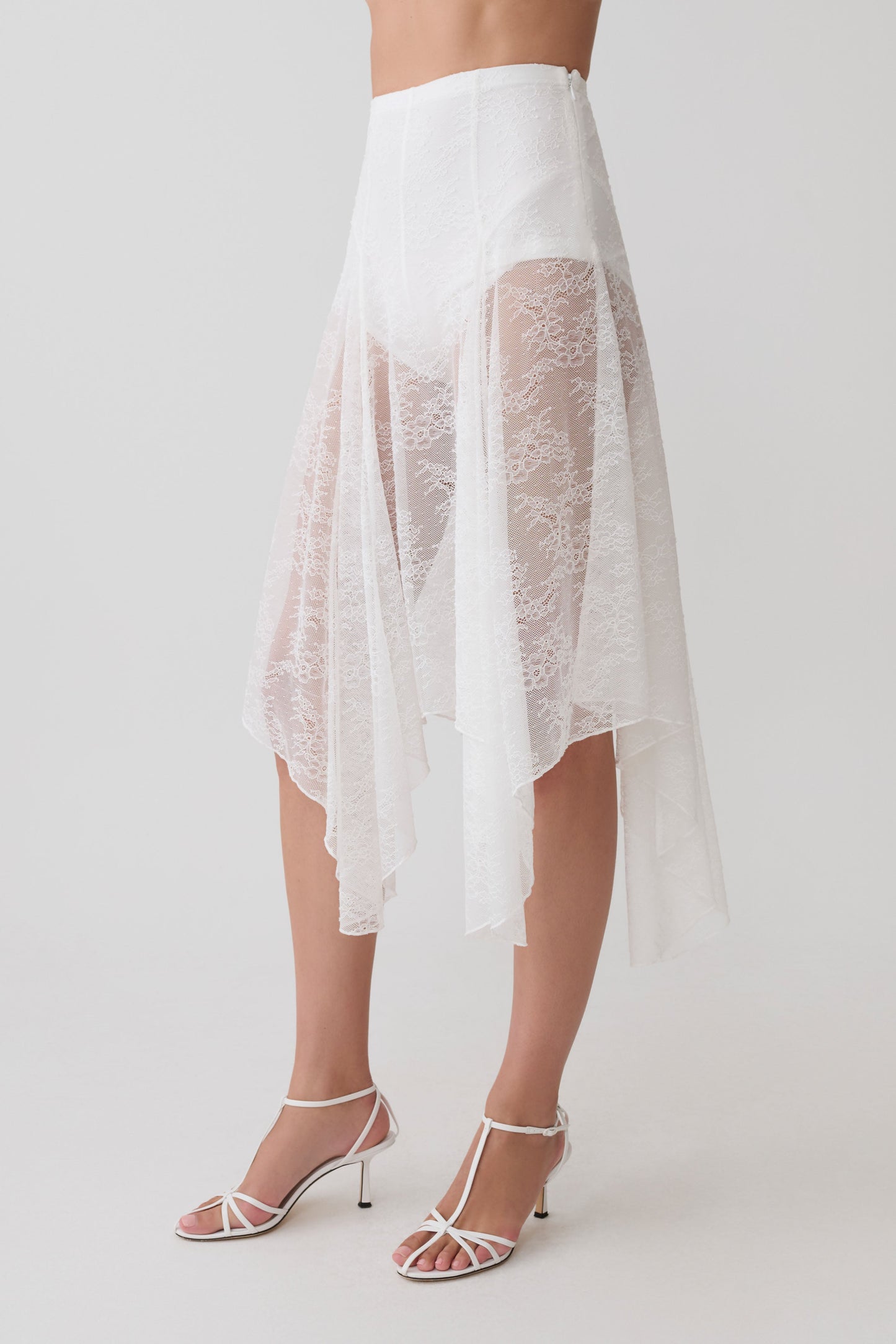 Woman wearing white lace skirt with shorts.
