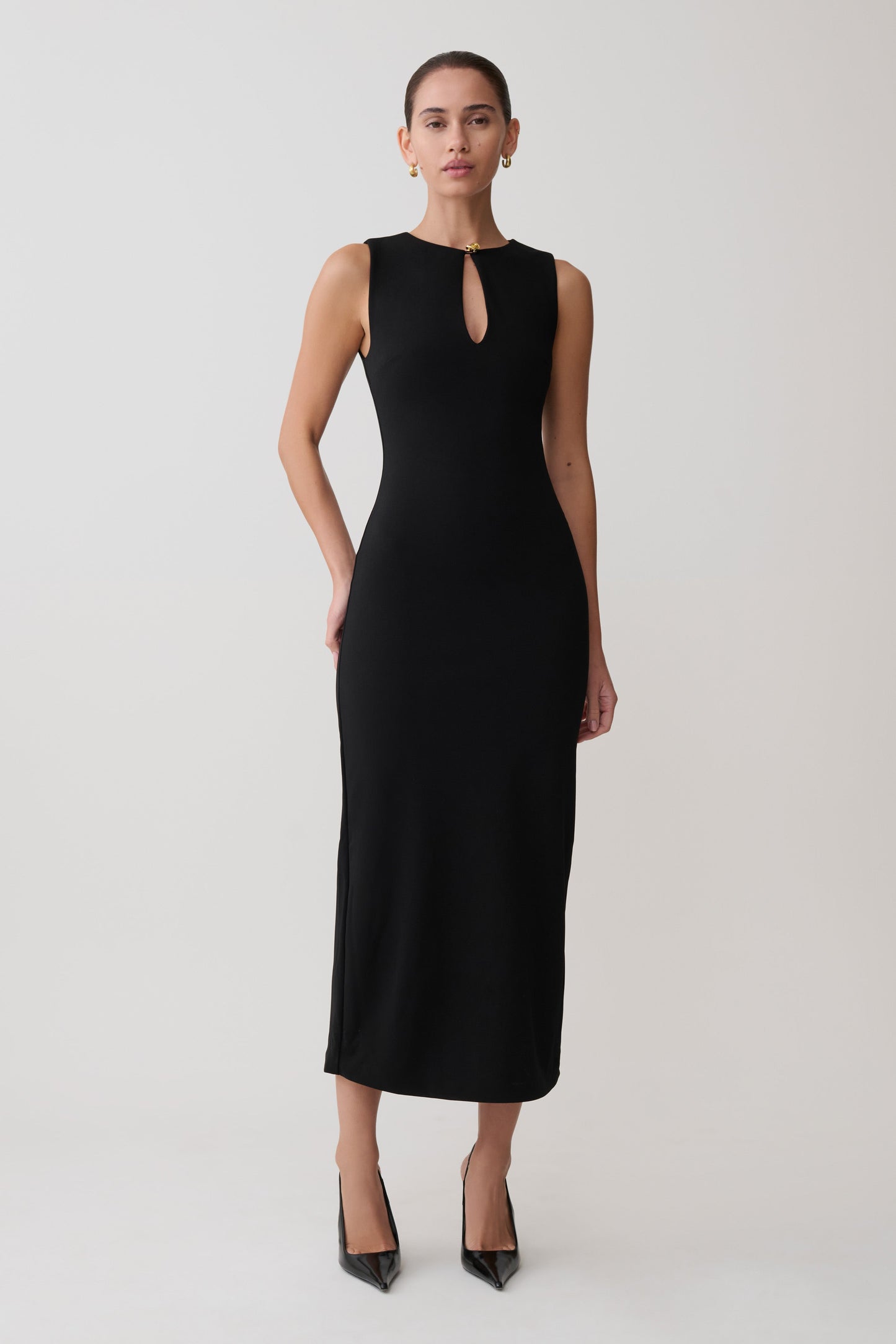 Woman wearing a black sleeveless dress on a white background