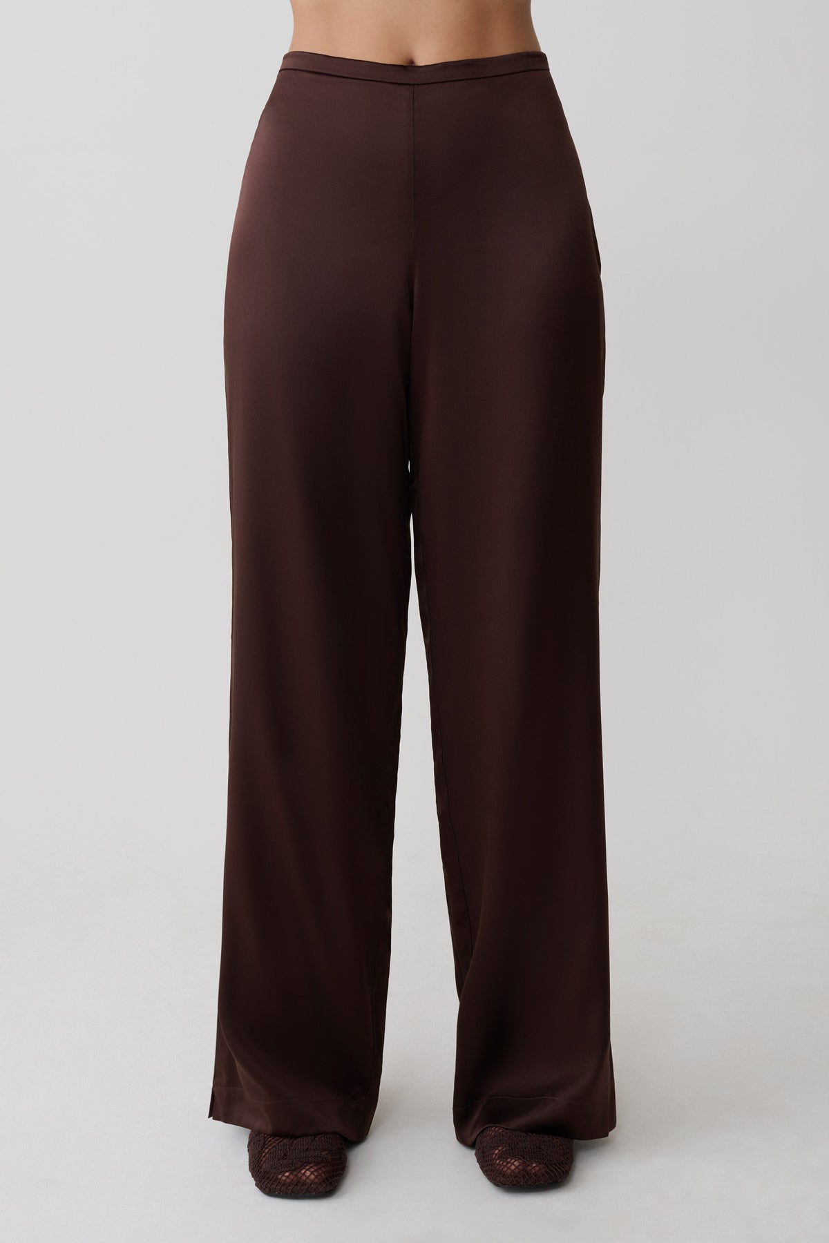 Woman wearing brown silk pants.
