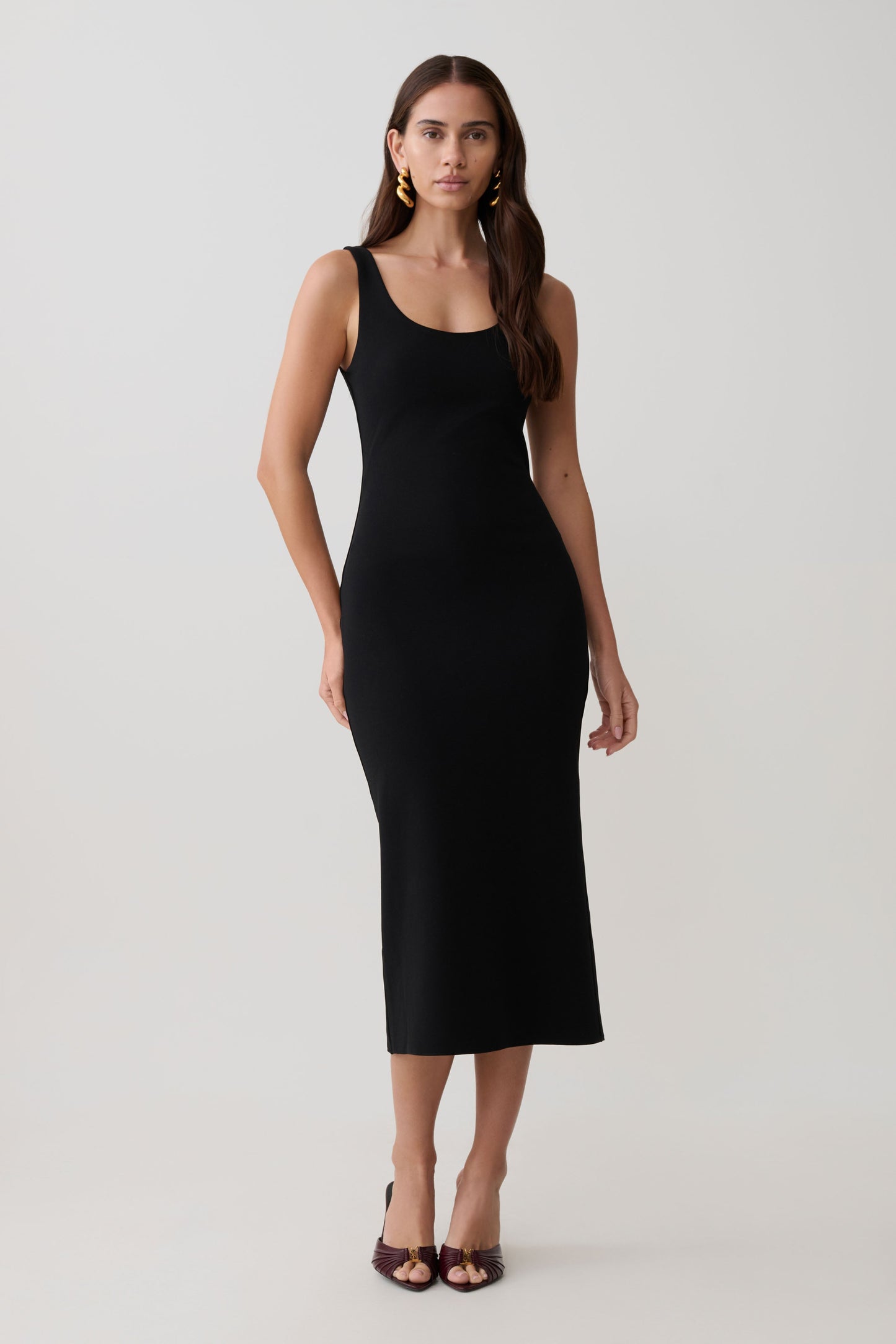 Woman wearing a black stretch crepe mini dress.