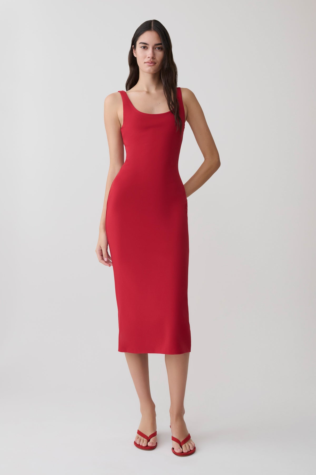 Woman wearing a red crepe midi dress.
