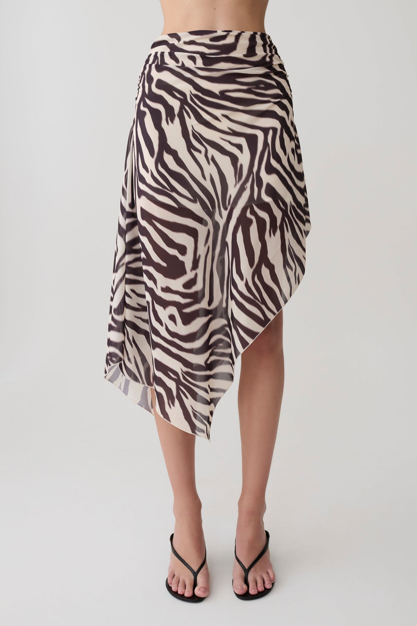 Woman wearing a zebra print chiffon midi skirt.