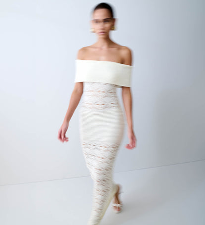 Woman in off shoulder white maxi dress.