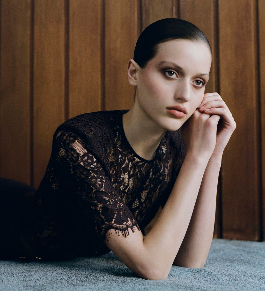 Image of woman in brown lace top.