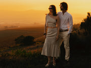 Image of couple in natural linen top and skirt set.
