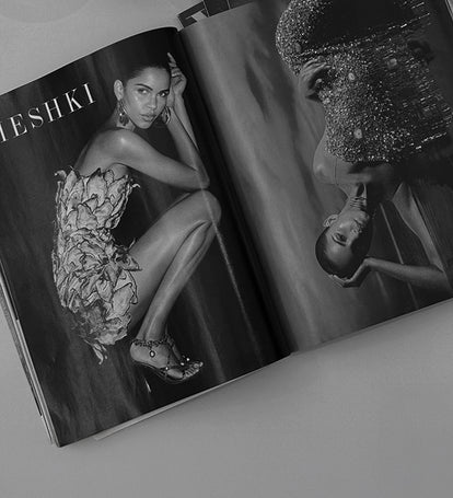 Open magazine showing a model in a floral dress with MESHKI branding.