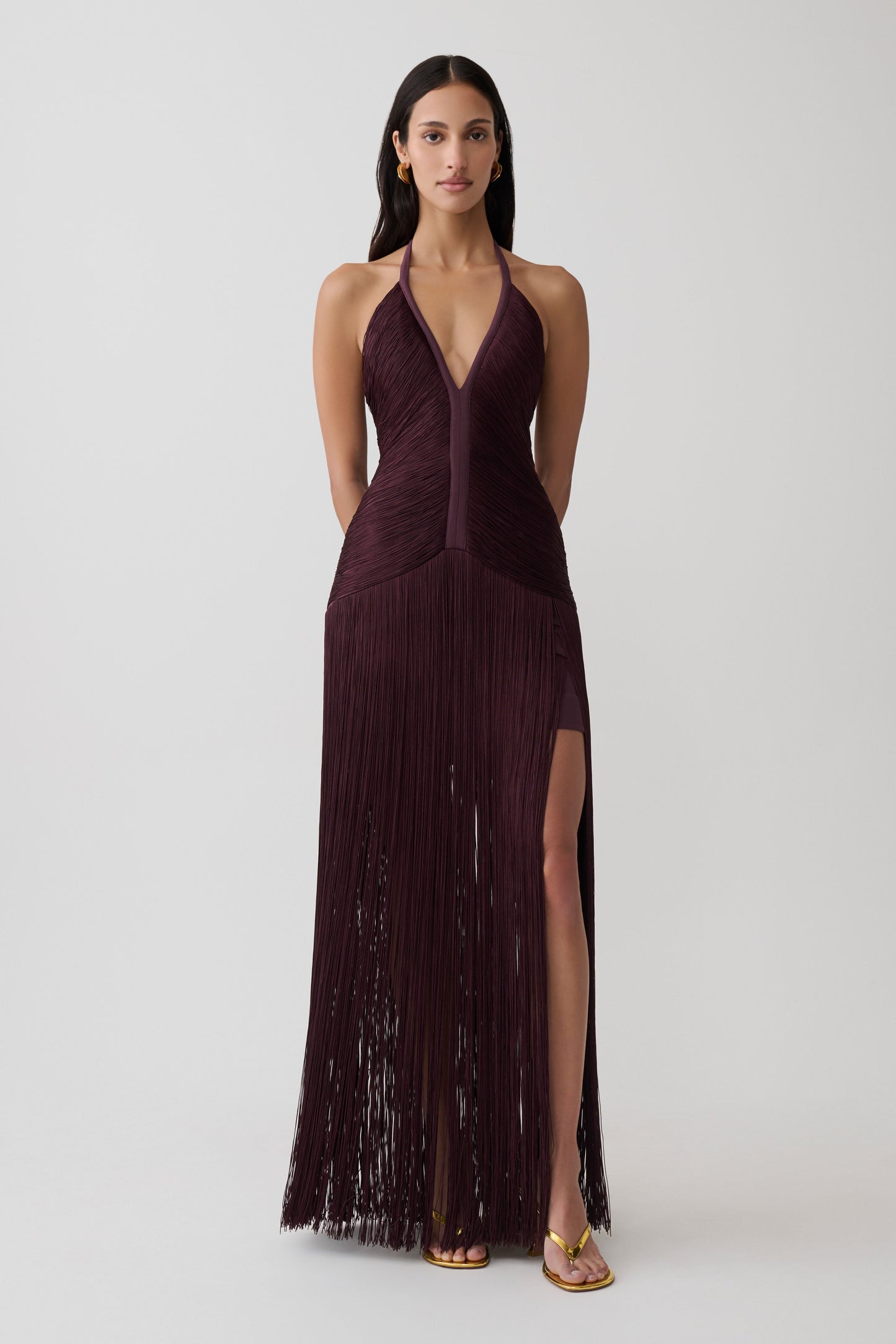 Woman wearing a purple fringe maxi dress.
