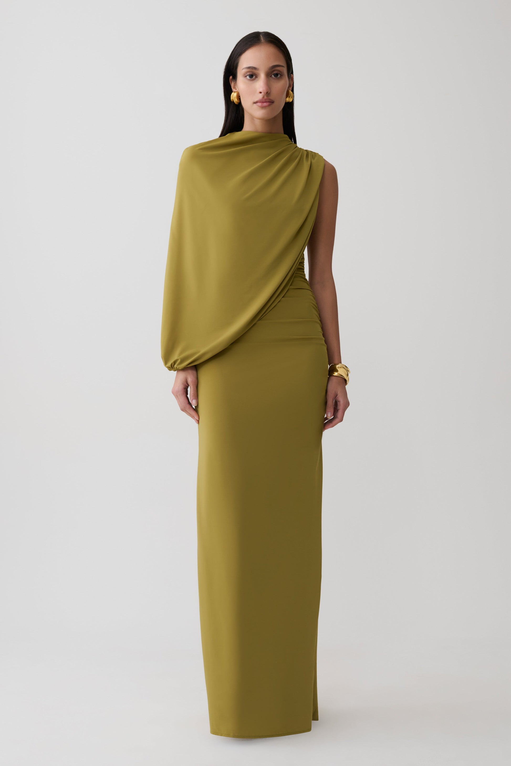 Woman wearing a green gather sleeve maxi dress.