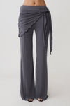 Woman wearing straight leg pants with waist wrap.