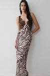 Woman wearing a zebra print lace and chiffon maxi dress.