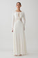 Woman wearing a white lace slinky maxi dress.