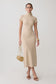 Woman wearing a beige high neck knit midi dress.