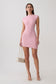 Woman wearing a pink ribbed sleeveless mini dress.