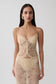 Woman wearing gold sweetheart lace top.