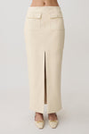 Woman wearing a white faux leather maxi skirt.