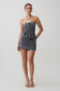 Woman wearing a grey halter with hardware mini dress.