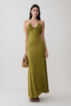 Woman wearing a green gathered slinky maxi dress.