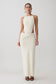 Woman wearing white sleeveless maxi dress.