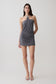 Woman wearing a grey halter with hardware mini dress.