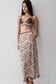 Woman wearing a a nude lace pencil midi skirt.