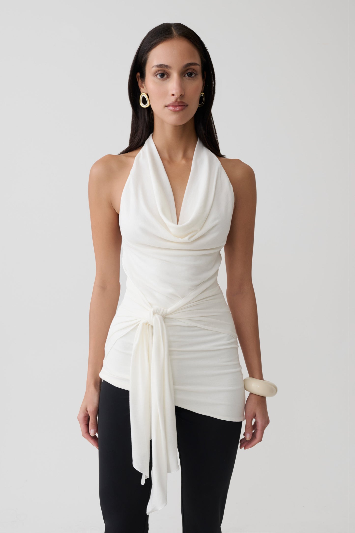 Woman wearing a white front tie halter top.