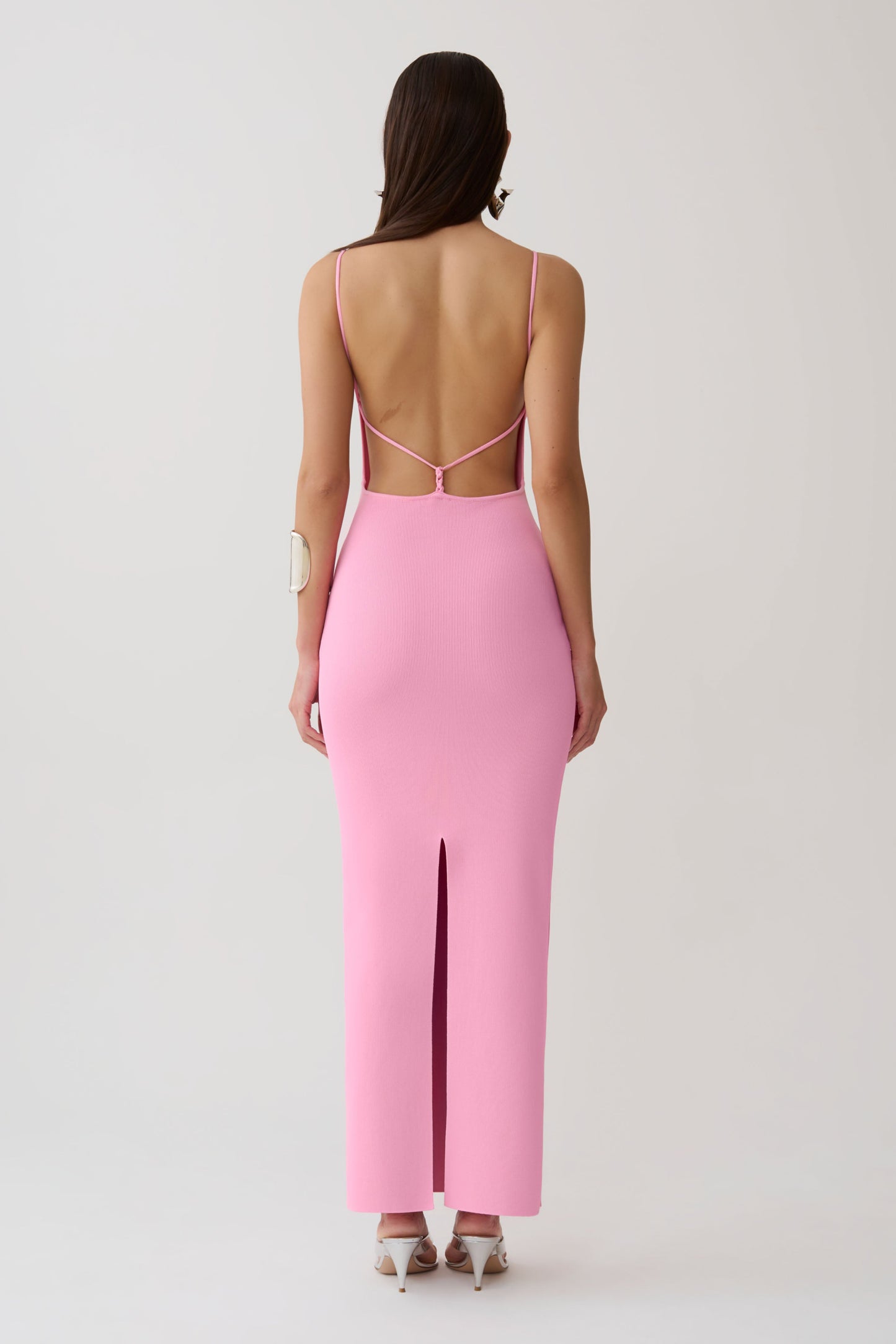Woman wearing a strappy back bandage maxi dress.