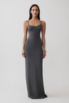 Woman wearing a grey peached jersey maxi dress.