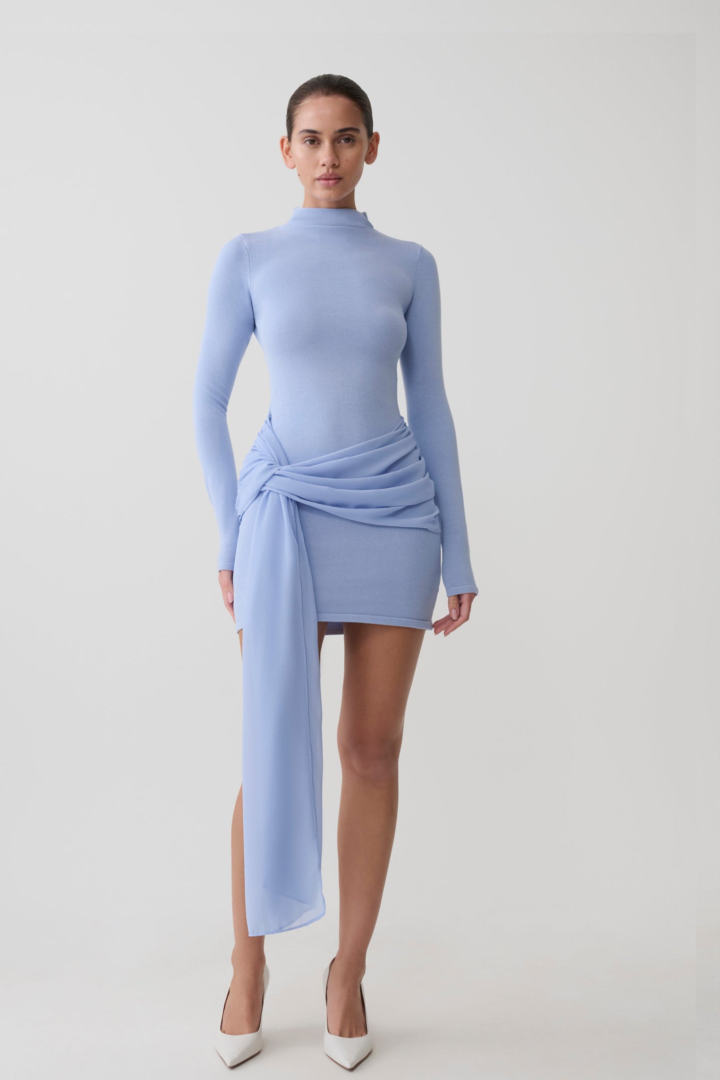 Woman wearing a blue knit chiffon mini dress.