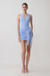 Woman wearing a light blue mini dress with crochet overlay.