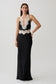 Woman wearing a black and white satin and lace maxi dress.