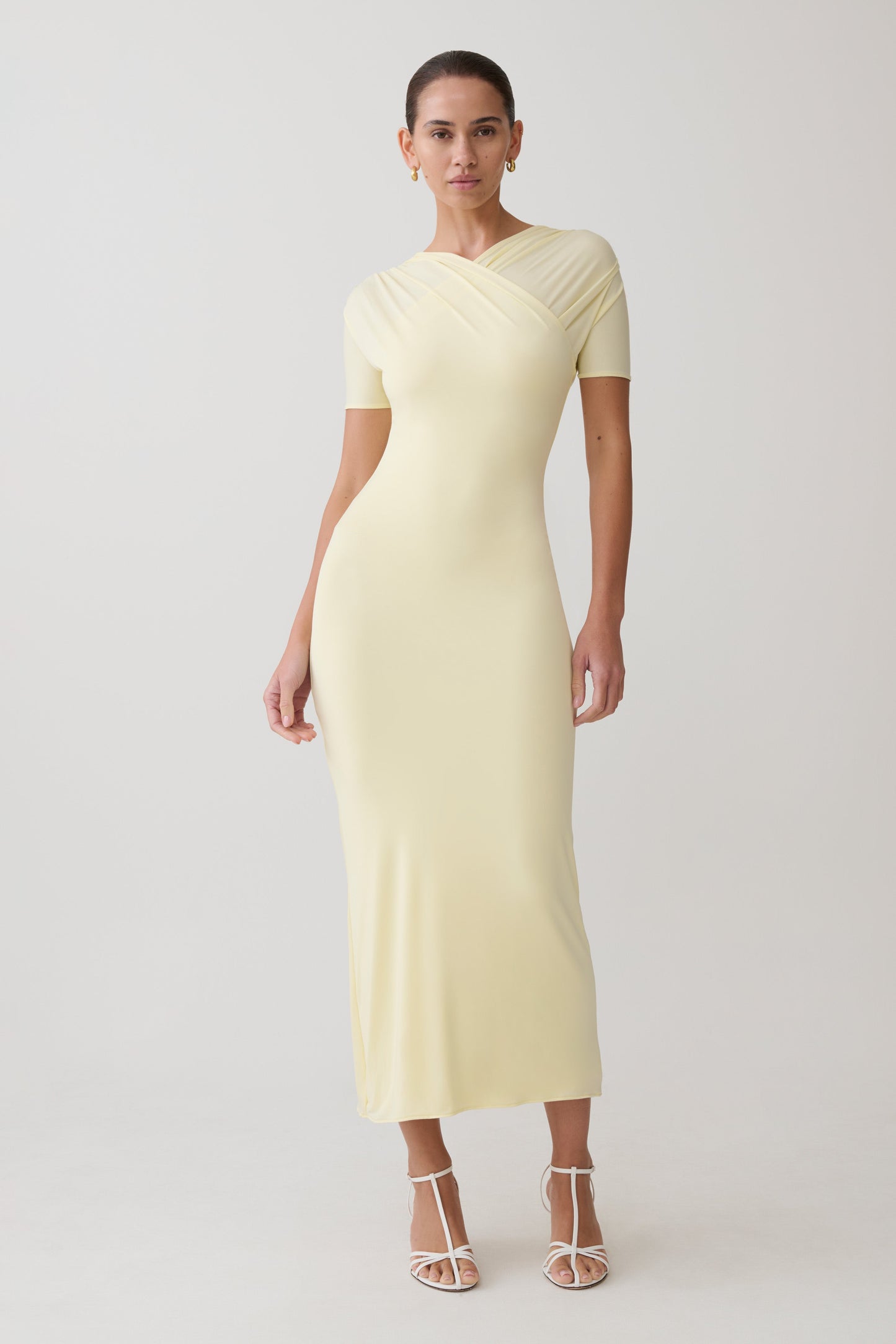 Woman wearing a light yellow maxi dress.