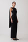 Woman wearing a black sleeveless dress with back scarf.