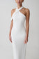 Woman wearing white crossover neck dress.