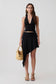 Woman wearing a black modal set with an asymmetrical midi skirt.