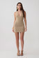 Woman wearing a lurex halter mini dress.