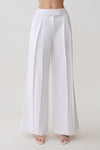 Woman wearing white mid rise wide leg pants.