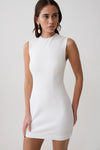 Woman wearing a white sleeveless stretch crepe mini dress.