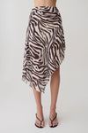 Woman wearing a zebra print chiffon midi skirt. 