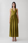 Woman wearing a green halter maxi dress.