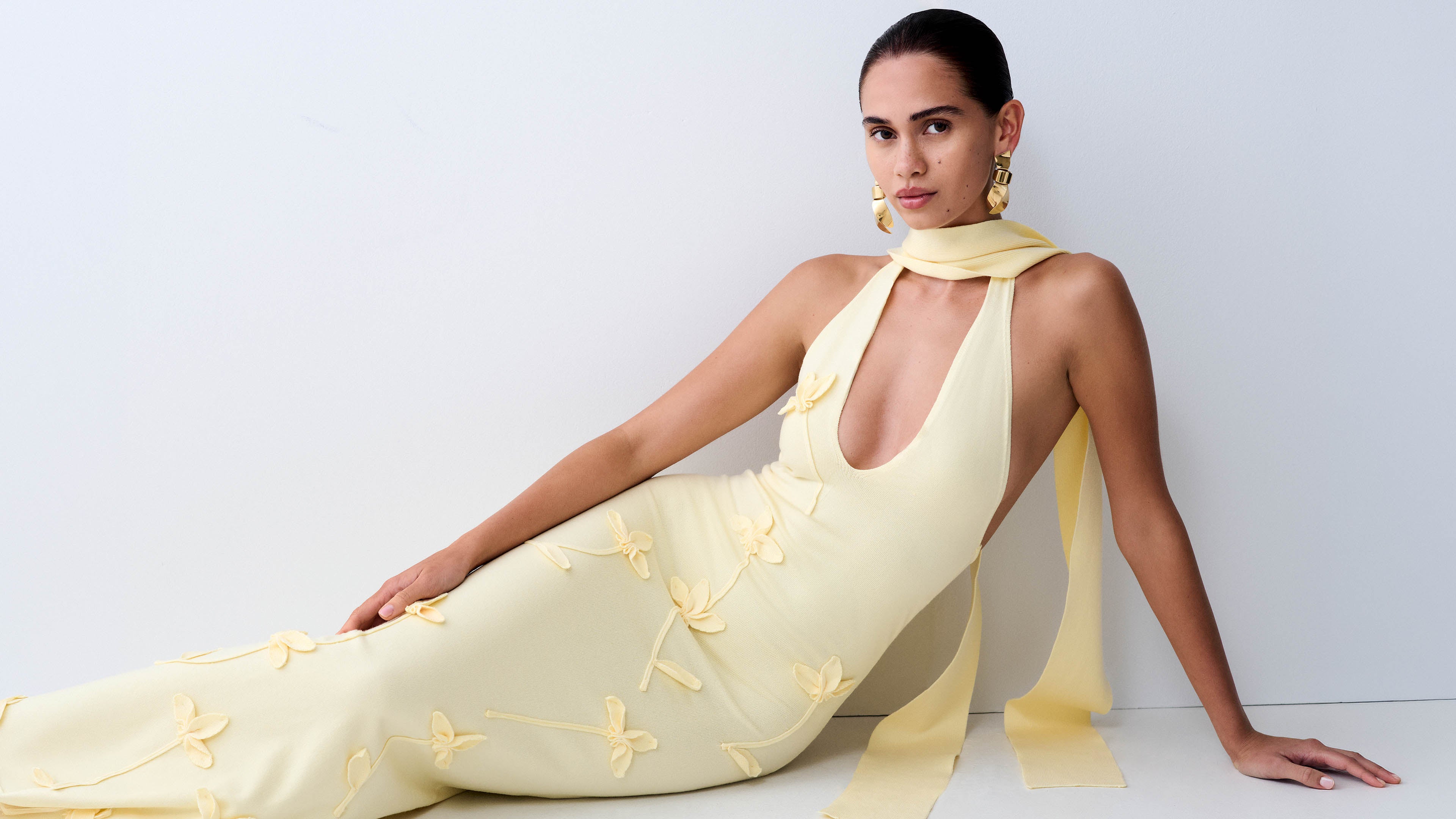 Woman in yellow knit dress.