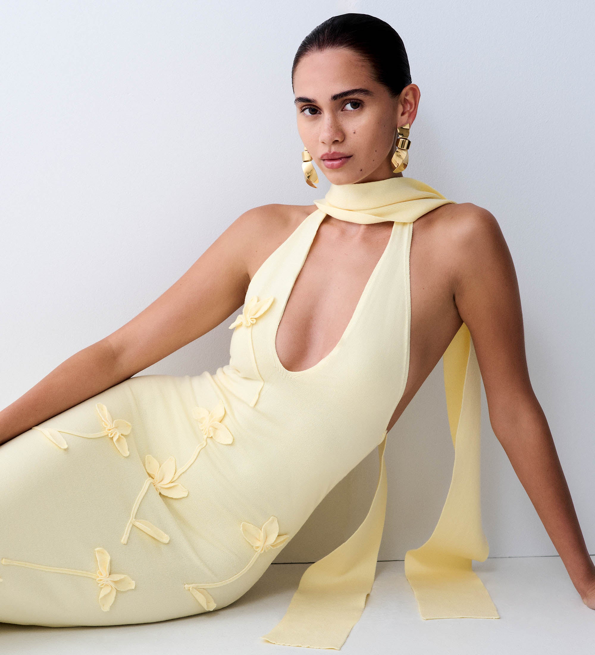 Woman in yellow knit dress.