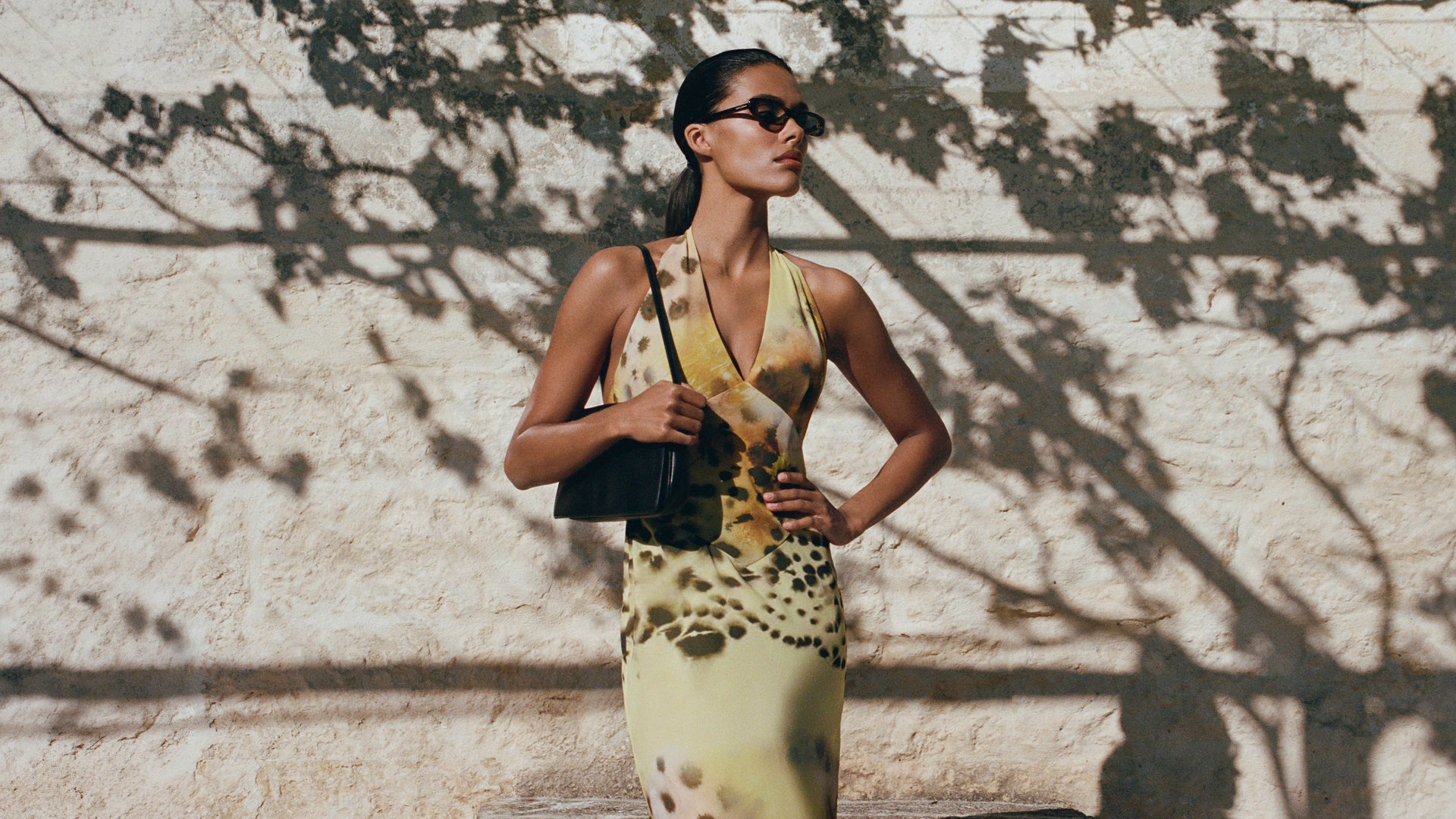 Image of woman in yellow print dress.