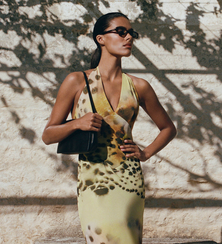Image of woman in yellow print dress.