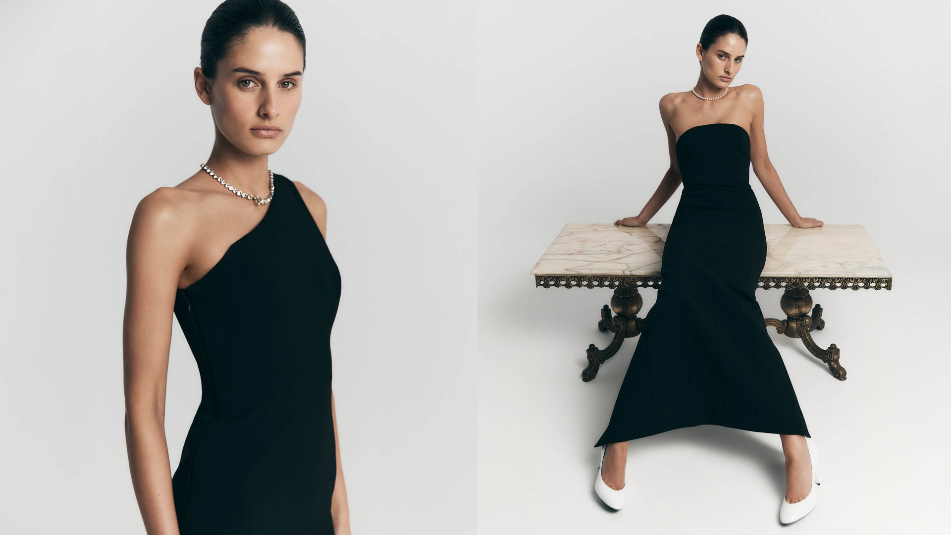 Woman wearing a black one shoulder and strapless dress against a white background.