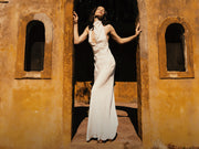 Image of woman in ivory maxi dress.