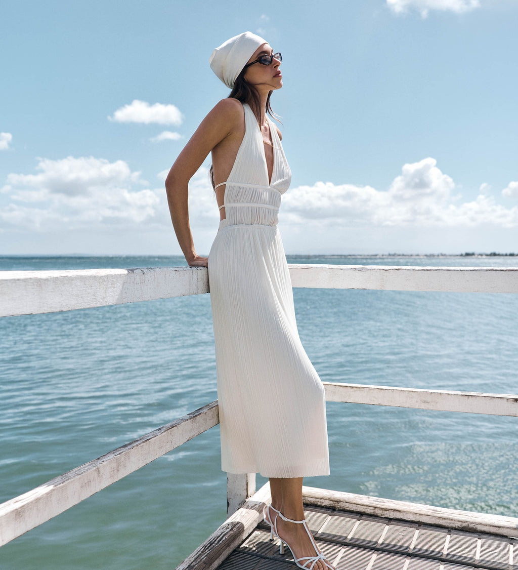 Image of woman in flowy white midi dress