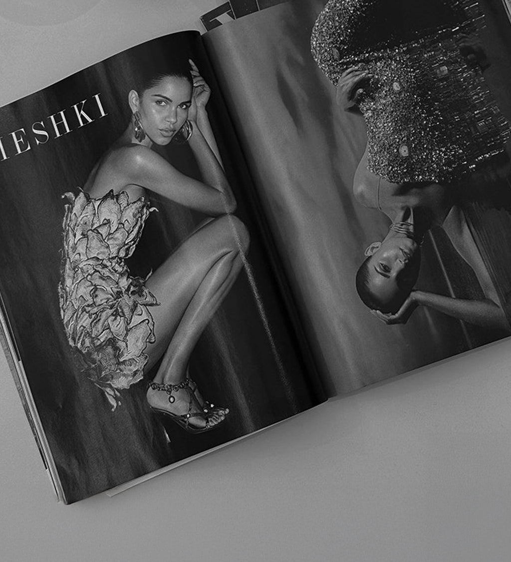 Open magazine showing a model in a floral dress with MESHKI branding.