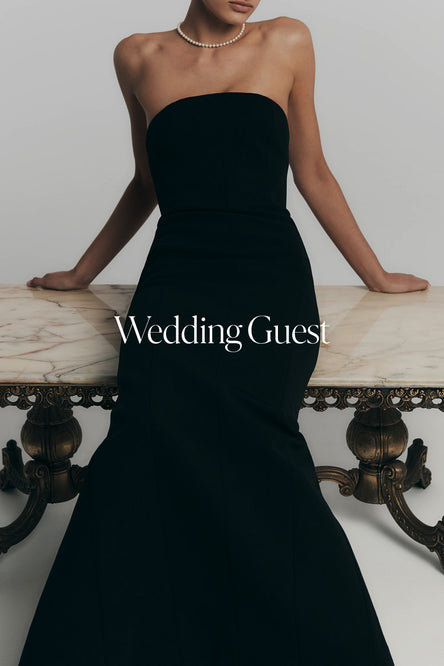 Woman in a black strapless dress.